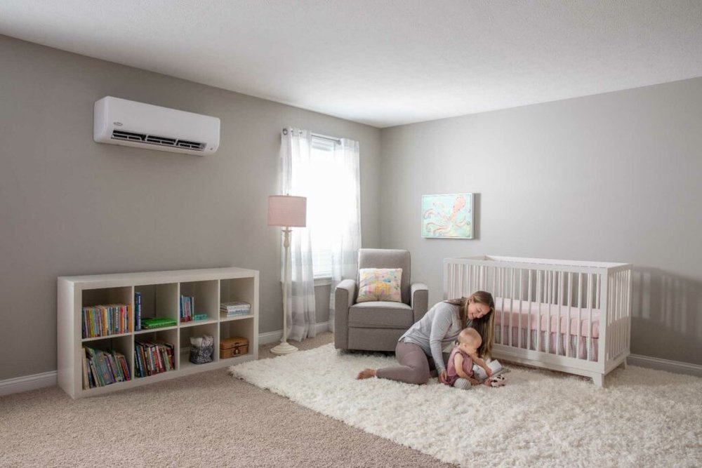 woman sitting on floor in nursery with child
