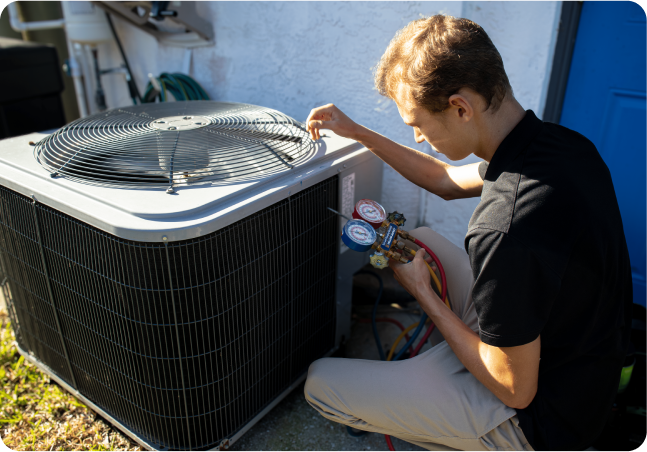 man working on AC unit outside